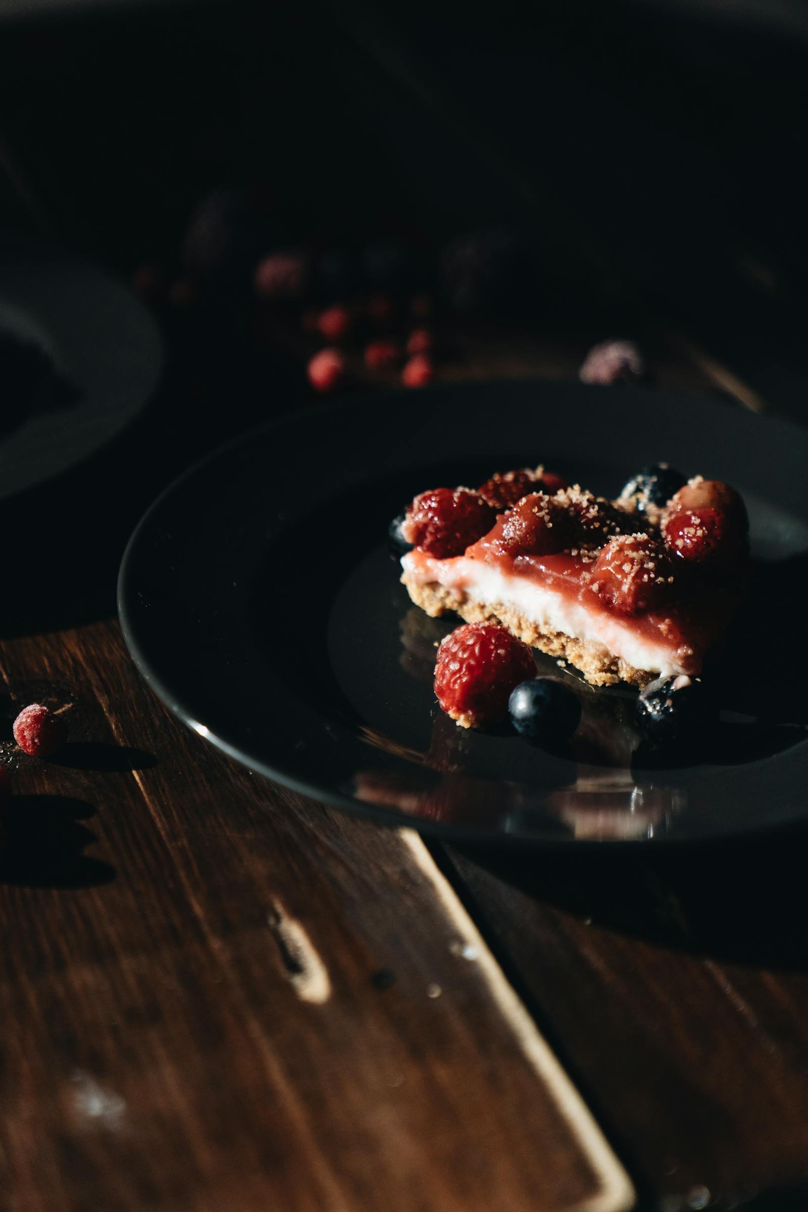 A bowl of saffron risotto on a rough ceramic plate, shot from above with a long shadow, deep umber palette.